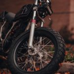 a motorcycle parked in front of a brick building