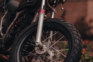 a motorcycle parked in front of a brick building