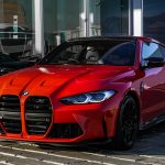 red bmw m 3 coupe parked on gray concrete pavement during daytime