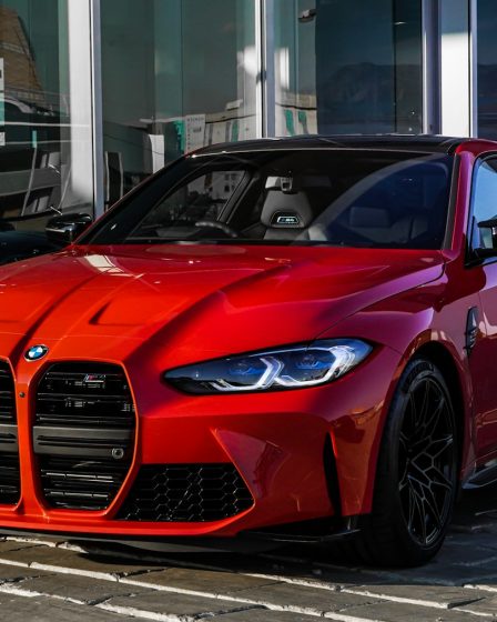 red bmw m 3 coupe parked on gray concrete pavement during daytime